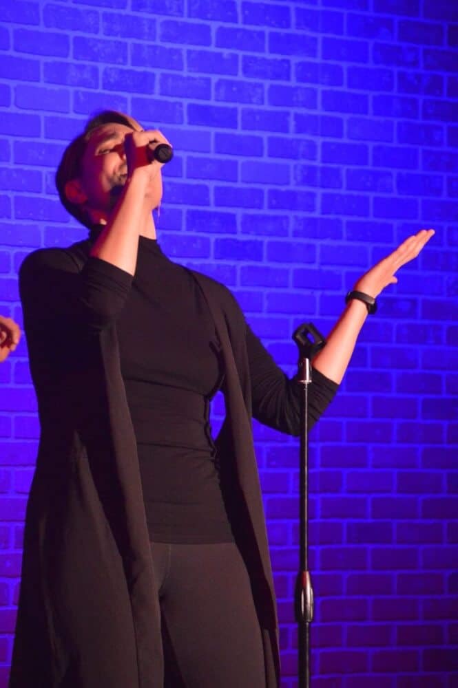 Ari Scheller singing at Unexpected Productions show photo by Bill Grinnel